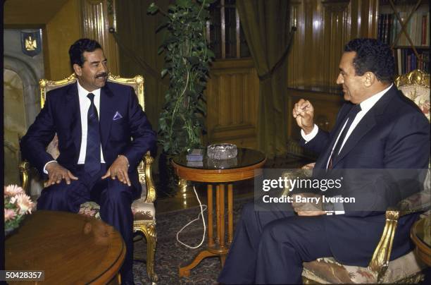 Egyptian Pres. Husni Mubarak meeting with Iraqi Pres. Saddam Hussein .