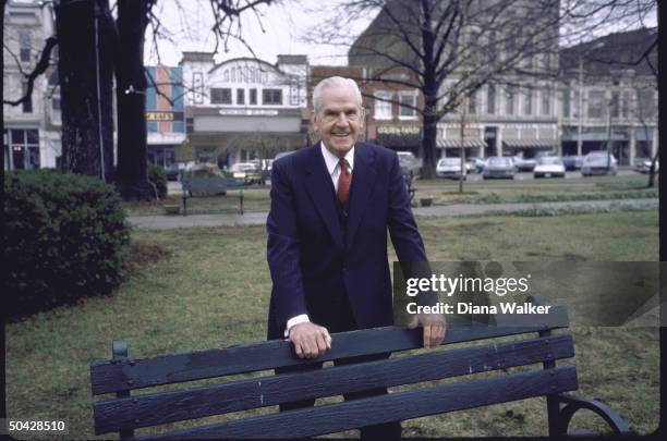 Rep. D-Ky. William H. Natcher, standing behind park bench.