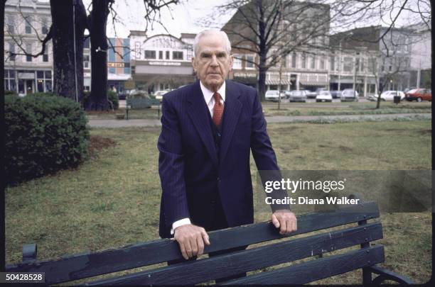 Rep. D-Ky. William H. Natcher, standing behind park bench.