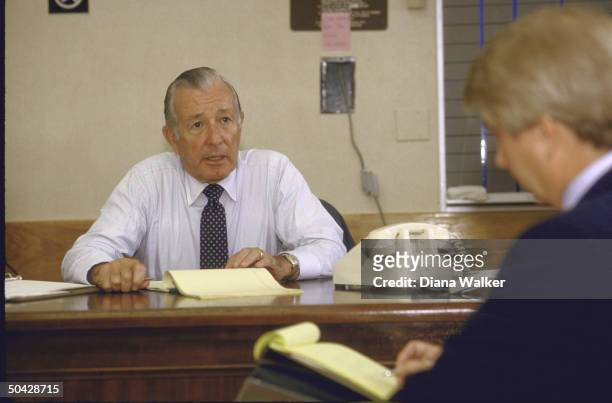 Chief of Staff Donald T. Regan in his office at Bethesda Naval Hospital briefing WH Press Secy. Larry M. Speakes regarding Pres. Ronald W. Reagan's...