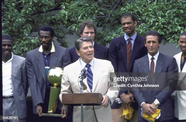 Pres. Ronald W. Reagan surrounded by Laker basketball players Scott McGee, Bob McAdoo, Mitch Kupchak, Kareem-Abdul Jabbar, Coach Pat Riley and Byron...