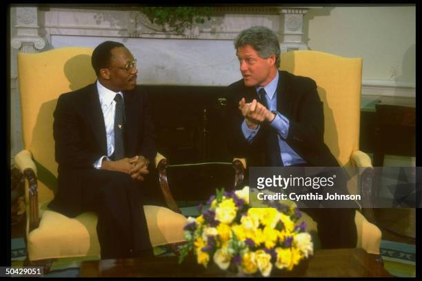 Pres. Bill Clinton mtg. W. Jean-Bertrand Aristide, deposed democratically-elected pres. Of Haiti, in WH Oval Office, re restoring him to office.