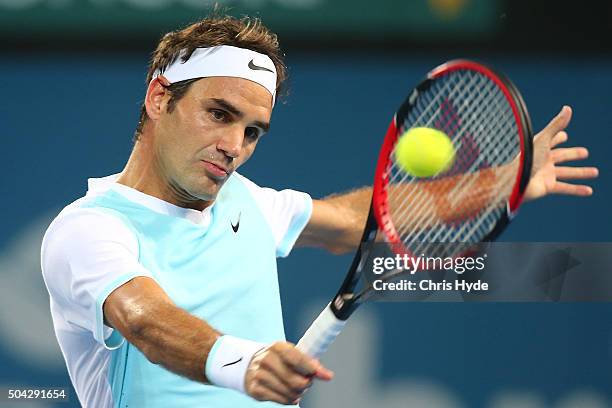 Roger Federer of Switzerland plays a backhand in the Mens Final against Milos Raonic of Canada during day eight of the 2016 Brisbane International at...
