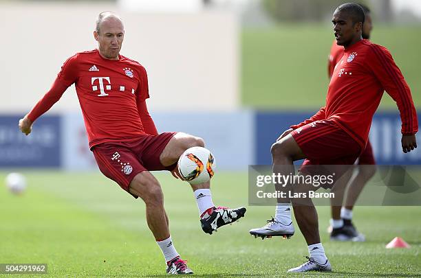 Arjen Robben is challenged by Douglas Costa during a training session at day five of the Bayern Muenchen training camp at Aspire Academy on January...