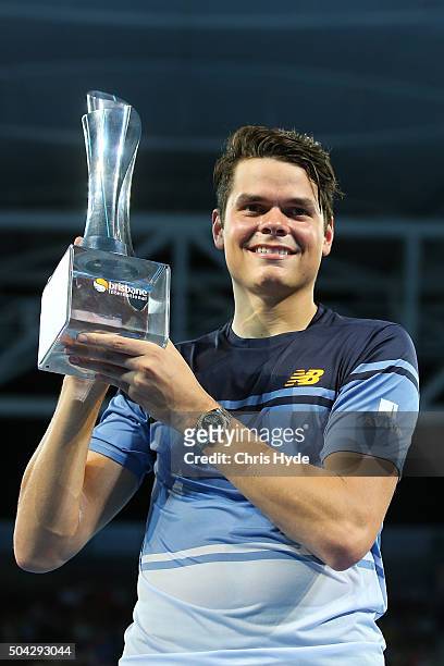 Milos Raonic of Canada holds the winners trophy after winning the Mens Final against Roger Federer of Switzerland during day eight of the 2016...