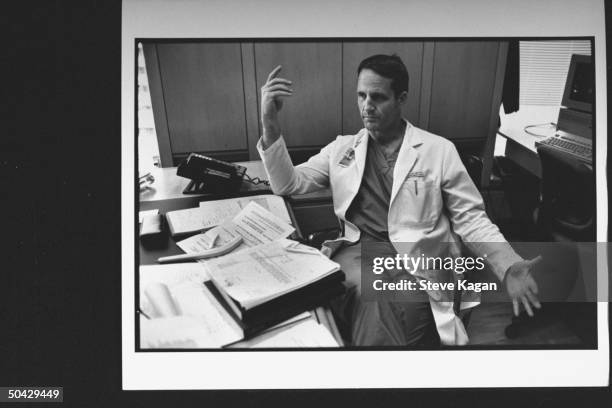 Cardiac Surgeon, Craig Smith, talking as he sits at desk in office at Columbia Presbyterian Medical Ctr.; Dr. Smith will help perform...
