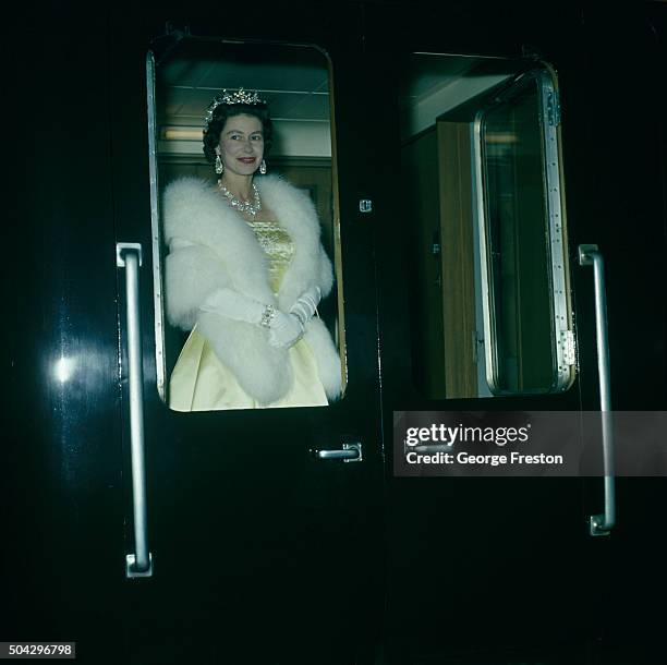 Queen Elizabeth II leaves on a train from Liverpool after attending an ice show, 24th May 1961.