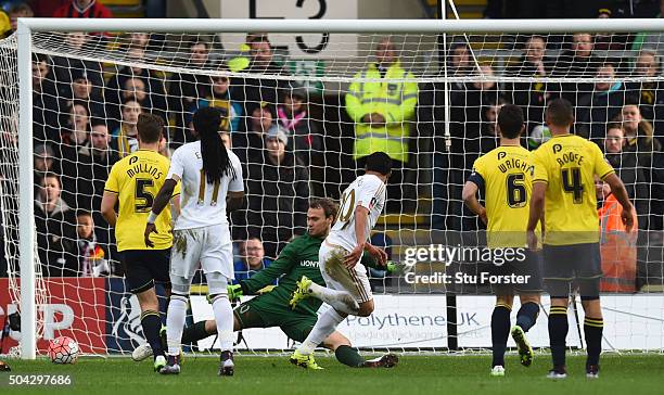 Jefferson Montero of Swansea City scores the opening goal past Sam Slocombe of Oxford United during The Emirates FA Cup third round match between...
