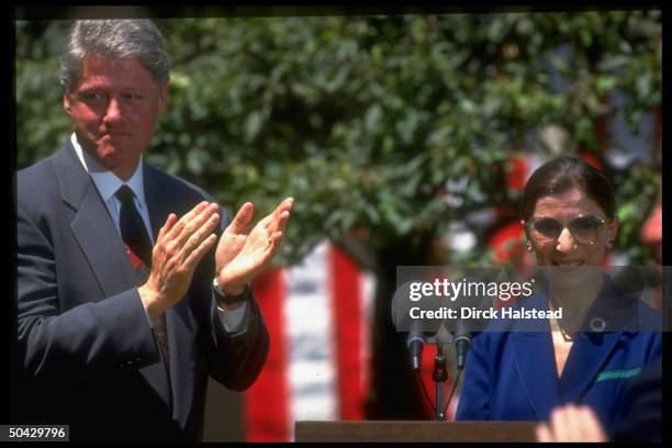 Sentimental Pres. Bill Clinton applauding Judge Ruth Bader Ginsburg after Supreme Court nominee's moving acceptance speech, in WH Rose Garden.