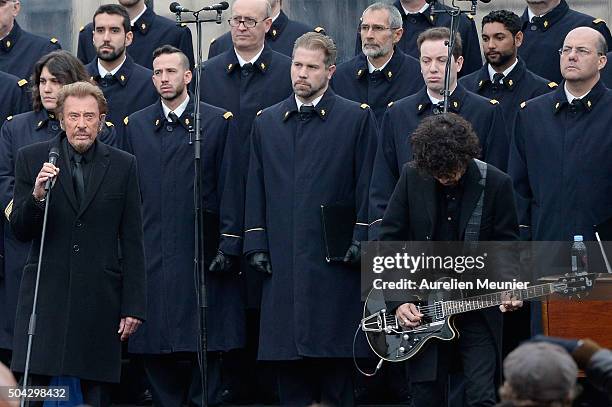 French singer, Johnny Hallyday performs as Parisians and Politicians gather at Place de la Republique to pay tribute to the 2015 terrorist attack...