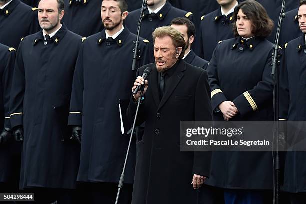 French singer Johnny Hallyday performs "Un dimanche de Janvier" with French army choir during The Tribute To 2015 Terrorist Attack Victims on January...