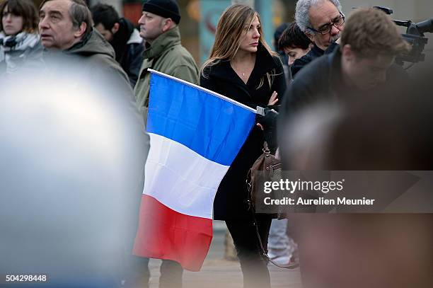 Woman with a French flag is seen as Parisians and Politicians gather at Place de la Republique to pay tribute to the 2015 terrorist attack victims on...