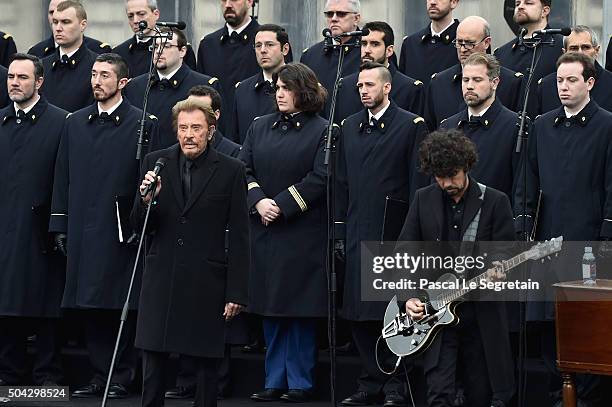 French singer Johnny Hallyday performs "Un dimanche de Janvier" with French army choir and Musician Yarol Poupaud during The Tribute To 2015...