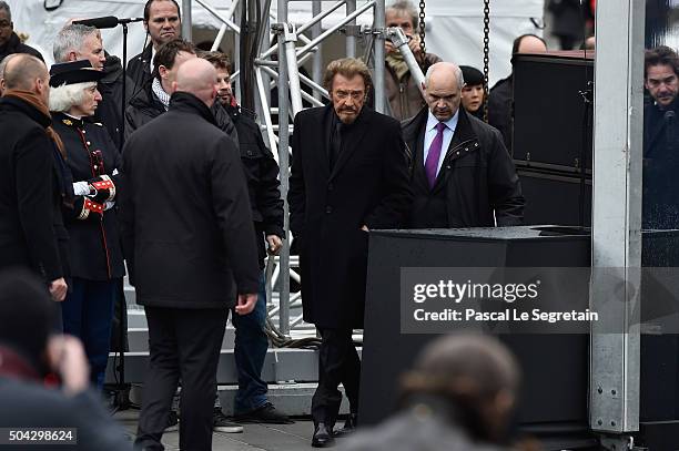 French Singer Johnny Hallyday arrives onstage to perform "Un dimance de Janvier" during The Tribute To 2015 Terrorist Attack Victims on January 10,...