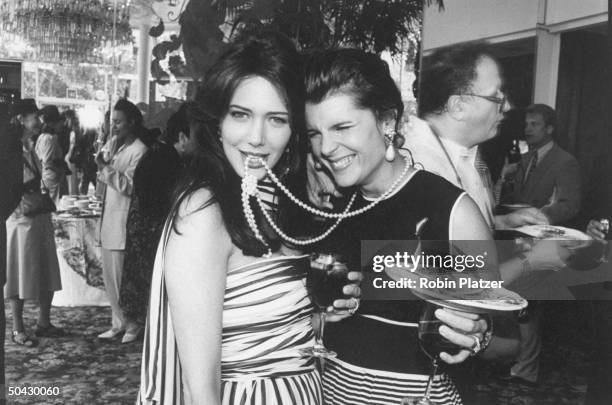 Actress Hunter Tylo biting the pearls of TV soap Bold And The Beautiful co-star Kimberlin Brown at a party at Tavern On The Green before the Daytime...