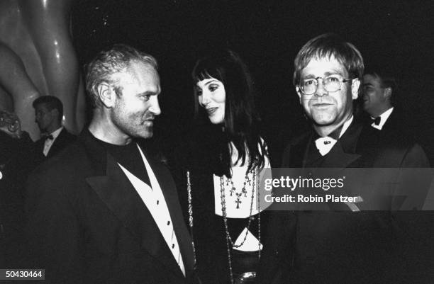 Actress Cher schmoozing w. Singer Elton John & fashion designer Gianni Versace at the 12th annual Council of Fashion Designers of America Awards...