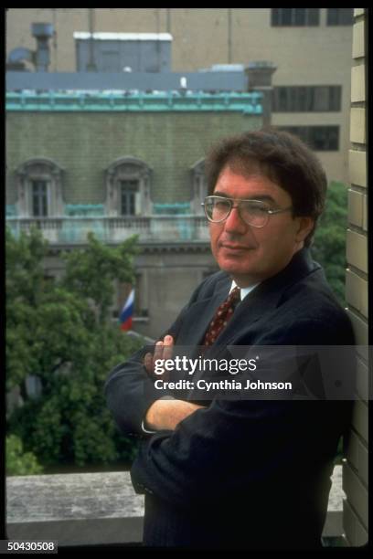 Author & former WASHINGTON POST investigative reporter Ronald Kessler standing on balcony across street fr. Russian Embassy.