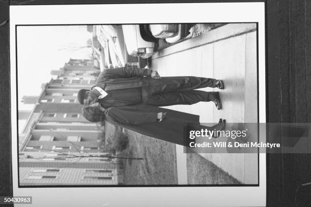 Bernadette Locke-Mattox, asst. Basketball coach at Univ. Of KY, kissing her husband Vince Mattox before leaving for work as they stand on sidewalk in...