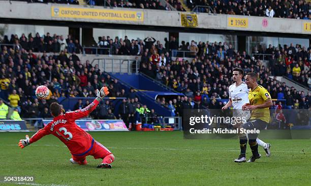 Kemar Roofe of Oxford United shoots past goalkeeper Kristoffer Nordfeldt of Swansea City to score his team's third goal during The Emirates FA Cup...