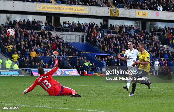 Kemar Roofe of Oxford United shoots past goalkeeper Kristoffer Nordfeldt of Swansea City to score his team's third goal during The Emirates FA Cup...