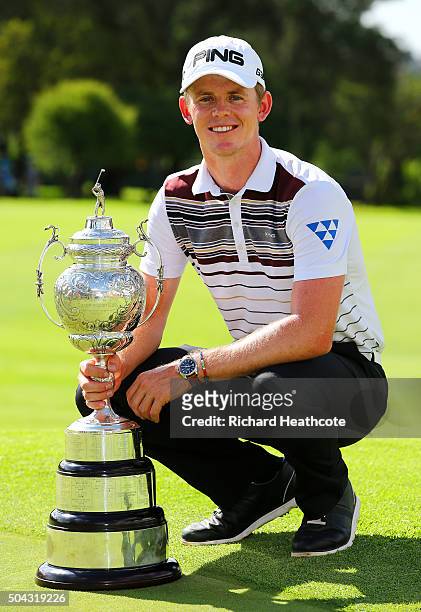 Champion Brandon Stone of South Africa poses with the South African Open trophy following his victory in the BMW SA Open at Glendower Golf Club on...