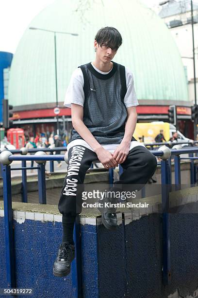 Model Vlad B wears a W.I.A vest and track suit trousers and Nike trainers on day 2 of London Collections: Men on Januay 9, 2016 in London, England.