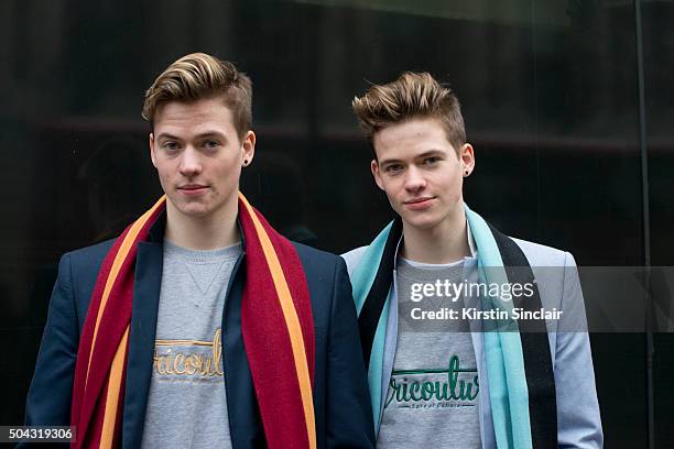 Model Kielan Edwards wears a H and M jacket and Eric Couture scarf and jumper, with model Cormack Edwards who wears River Island blazer and Eric...