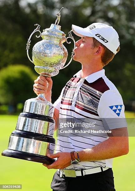 Champion Brandon Stone of South Africa poses with the South African Open trophy following his victory in the BMW SA Open at Glendower Golf Club on...