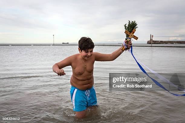 Adam Marinou from Canterbury retrieves a crucifix from the sea during a traditional Greek Orthodox blessing at Margate beach for the Feast of the...