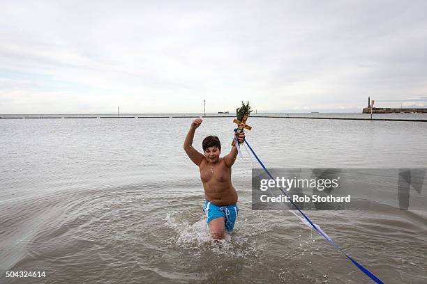 Adam Marinou from Canterbury retrieves a crucifix from the sea during a traditional Greek Orthodox blessing at Margate beach for the Feast of the...