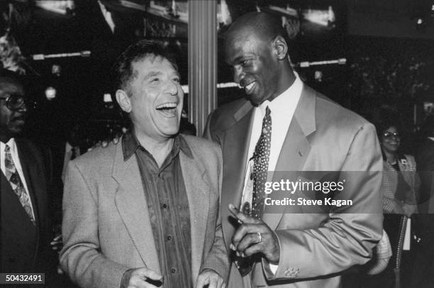 Chicago Bulls basketball star Michael Jordan chatting w. Actor George Segal at the opening of his Michael Jordan's restaurant.