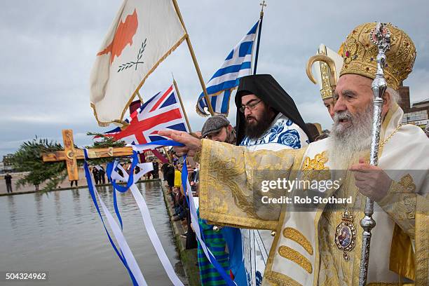 His Eminence Gregorios, Greek Orthodox Archbishop of Thyateira and Great Britain throws a crucifix into the sea at Margate beach during celebrations...