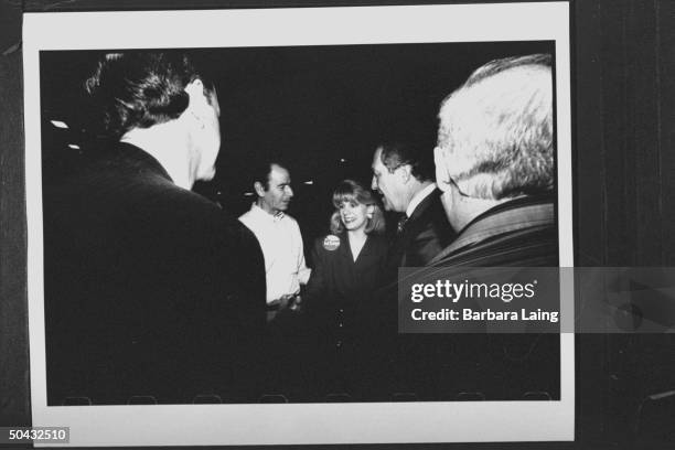 Sen. Bob Krueger w. Wife Kathleen Tobin Krueger shaking hands & chatting w. Four unident. Men at campaign function at the Jefferson County...