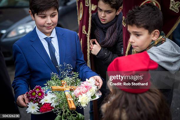 Adam Marinou from Canterbury carries a crucifix in a procession to Margate beach during traditional Greek Orthodox celebrations for the Feast of the...