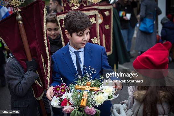 Adam Marinou from Canterbury carries a crucifix in a procession to Margate beach during a traditional Greek Orthodox celebrations for the Feast of...