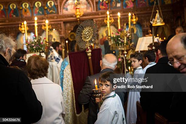 Parishioners and clergy of the Greek Orthodox Church of St Michael the Archangel attend a service for Feast of the Epiphany lead by His Eminence...