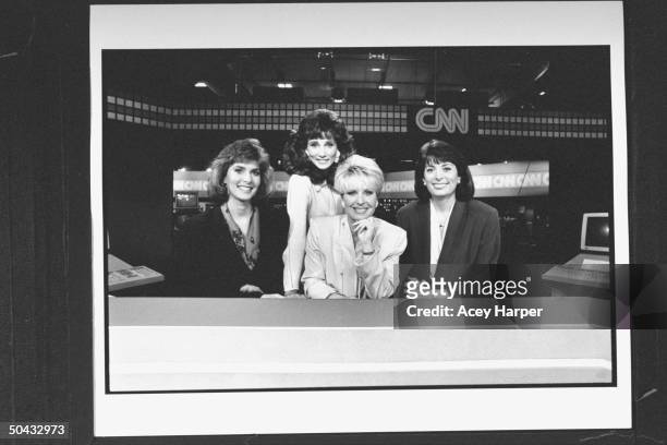 Anchors Cheryl Atkisson, Valerie Voss, Bobbie Battista & Donna Kelley posing at desk on set before a broadcast at Cable News Network HQ.