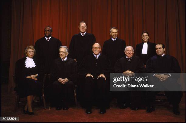 Supreme Court Justices Scalia, Ginsburg, Stevens, Souter, Chief Rehnquist, Kennedy, Blackmun, Thomas & O'Connor sitting for portrait.