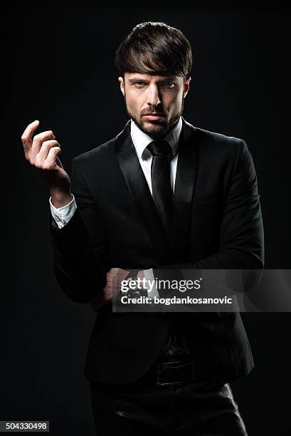 elegant man dressed in black - black tuxedo stock pictures, royalty-free photos & images