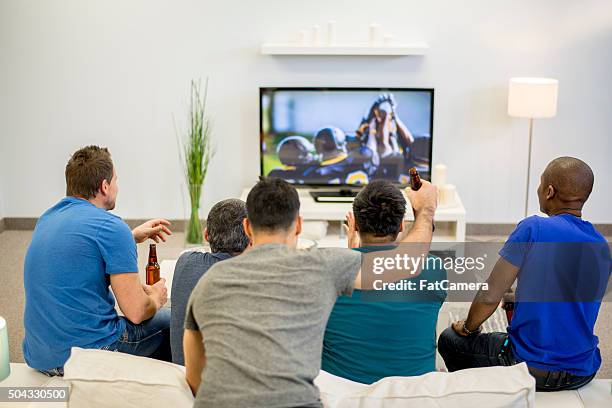 friends watching the game together - american football game stockfoto's en -beelden