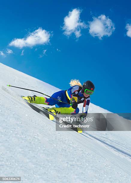 female skier at straight downhill ski race - alpineskiën stockfoto's en -beelden