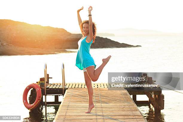 young woman dancing on the pier - women with nice legs stock pictures, royalty-free photos & images