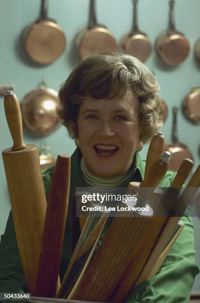 Chef Julia Child posing w. Assorted rolling pins.