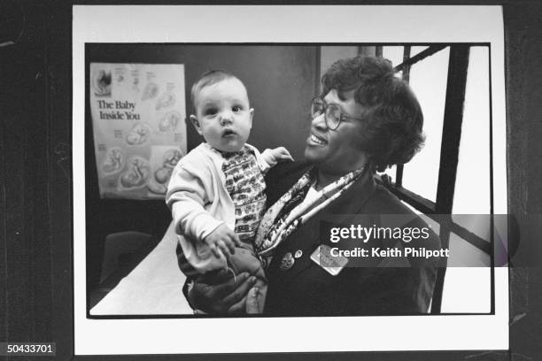 Pres. Clinton's Surgeon Gen. Nominee Dr. Joycelyn Elders, the dir. Of the AR Dept. Of Public Health, holding infant boy at the Central HS Wellness...