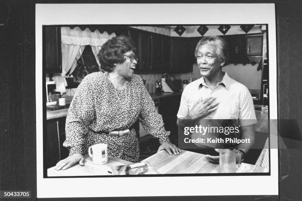 Surgeon Gen. Nominee Dr. Joycelyn Elders chatting w. Her husband Oliver nr. Kitchen counter at home.