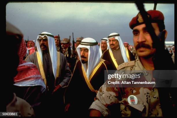 Emir of Kuwait, Sheik Jaber Ahmed al-Sabah surrounded by soldiers as he returns to his homeland after the end of the Gulf War.