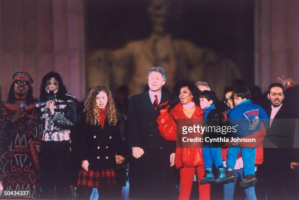 Pres-elect Bill Clinton holding hands w. Daughter Chelsea, flanked by stars incl. Stevie Wonder, Michael Jackson & Diana Ross, during Inaugural-wk....