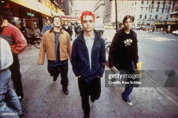 Punk rock trio Green Day bassist Mike Dirnt, vocalist & guitarist Billie Joe & drummer Tre Cool sauntering streets of NYC.
