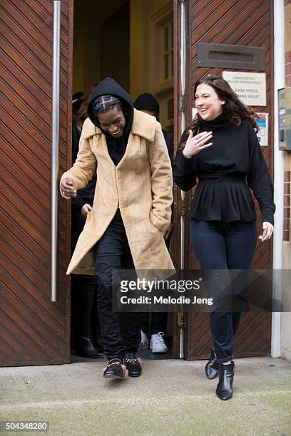 Rapper ASAP Rocky exits the J.W. Anderson show in a beige coat, black hoodie and trousers, and Gucci fur-lined loafers during The London Collections...