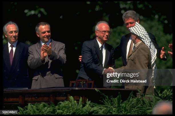 Chmn. Arafat shaking hands w. Israeli PM Rabin, w. Christopher, Clinton, Kozyrev & Peres during WH signing of PLO/Israel peace accord.